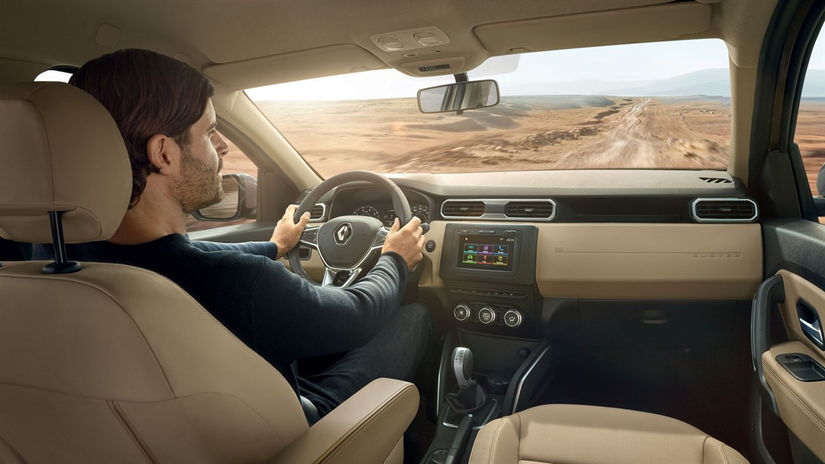 A man driving All-New Renault Duster in a hilly area
