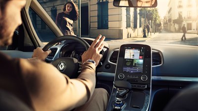 A man driving his Renault car using the R-LINK 2 system