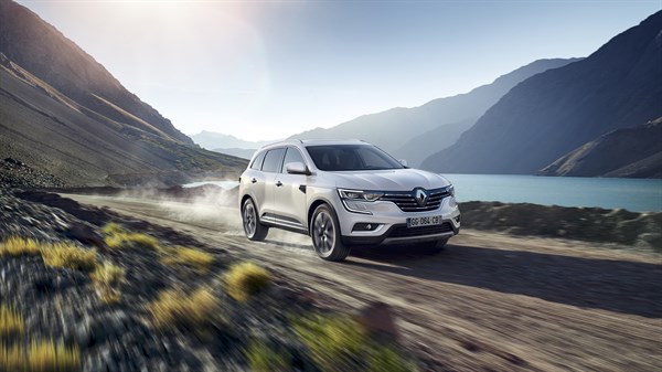 Renault Koleos is moving in a pleasant location of the mountain & river