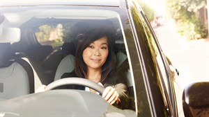 A woman driving Renault car